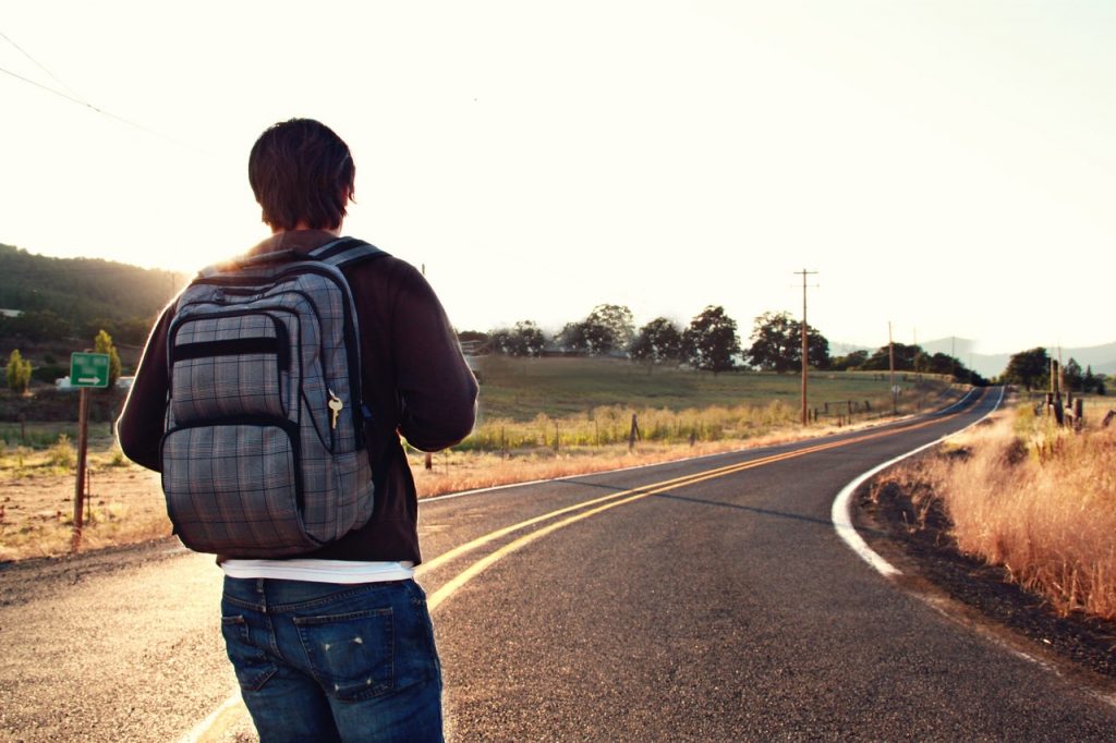 man with backpack on the road