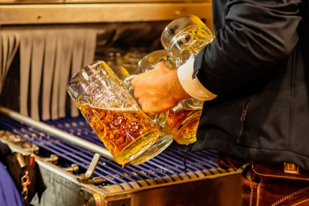 guy holding beer mugs - featured image